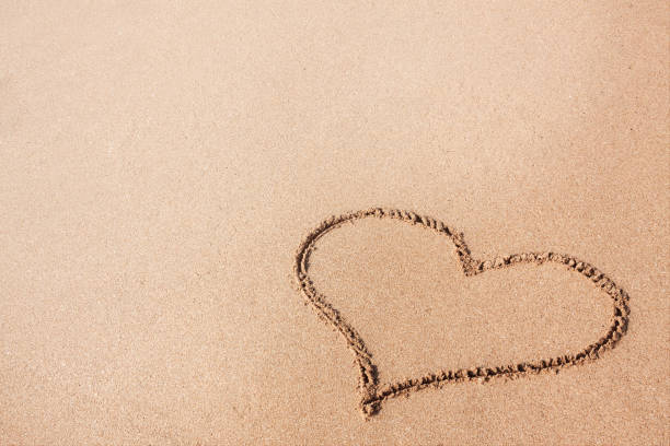 istock Drawing of a Heart on a Yellow Sand Beach. 882101908