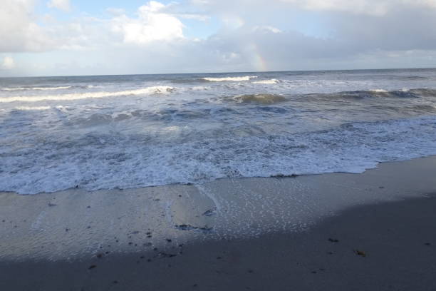 istock rainbow over the ocean after a storm 882111616