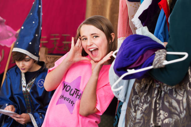 istock Girl in dressing room poses with hands by face 882112002