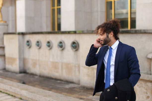 istock Hispanic businessman calling partner with phone near Eiffel Towe 882112210