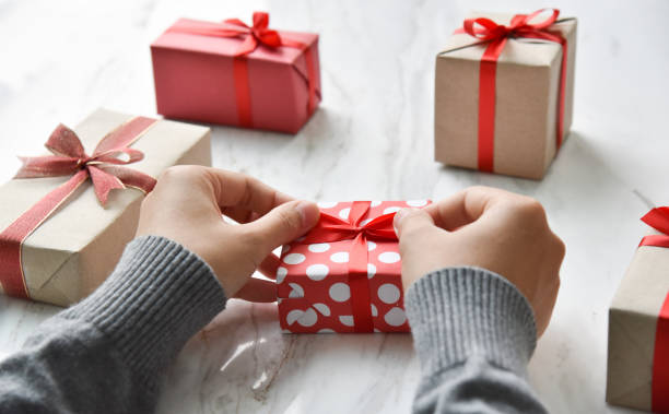 istock Top view of Female hands wrapping  present boxes 882115758