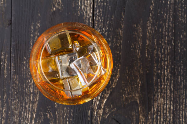 istock Glasses of whiskey on wood background. 882125242
