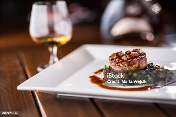 Beef Steak Grill Beef Steak Black Lentils Mixed With Vegetable Cognac Or Brandy As Drink Culinary Food In Hotel Pub Or Restaurant Stock Photo - Download Image Now