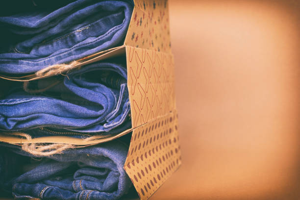 istock Women's jeans folded in a pile on a colored background. Made in a vintage performance 882128444