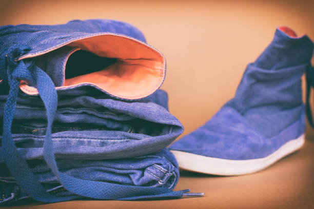 istock Denim clothes and shoes on a colored background. Vintage 882128710