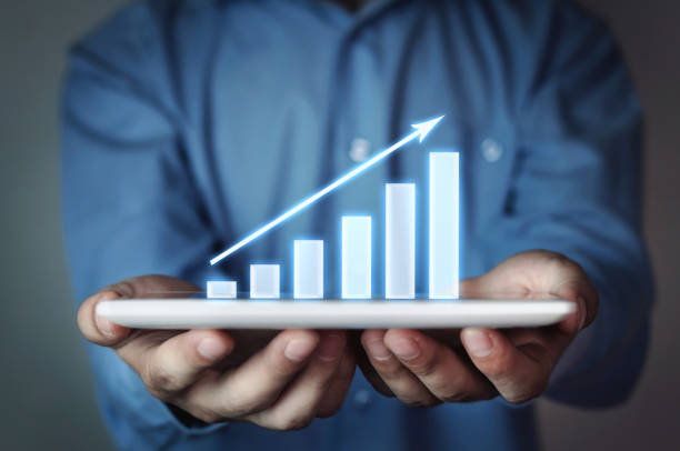 istock Businessman holding business graph. 882129346