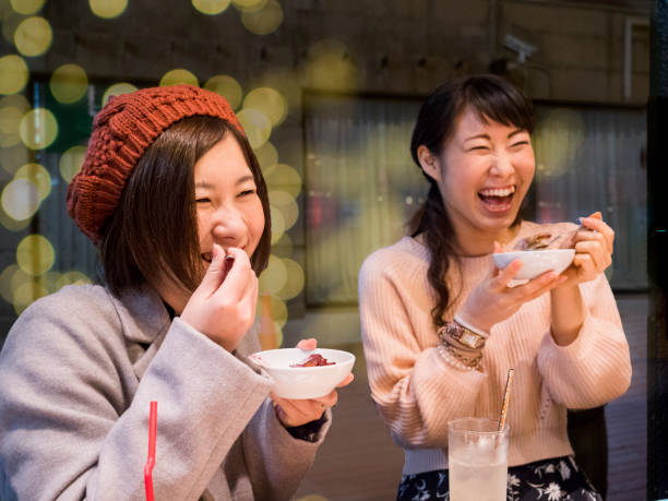 istock Japanese young ladies enjoy eating a dinner. 882132658