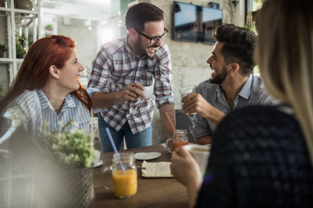 istock Group of cheerful friends talking about something funny in a cafe. 882144264