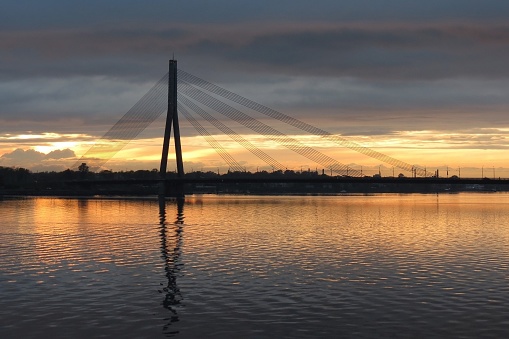 The cable-stayed bridge across the Daugava River in Riga during sunset