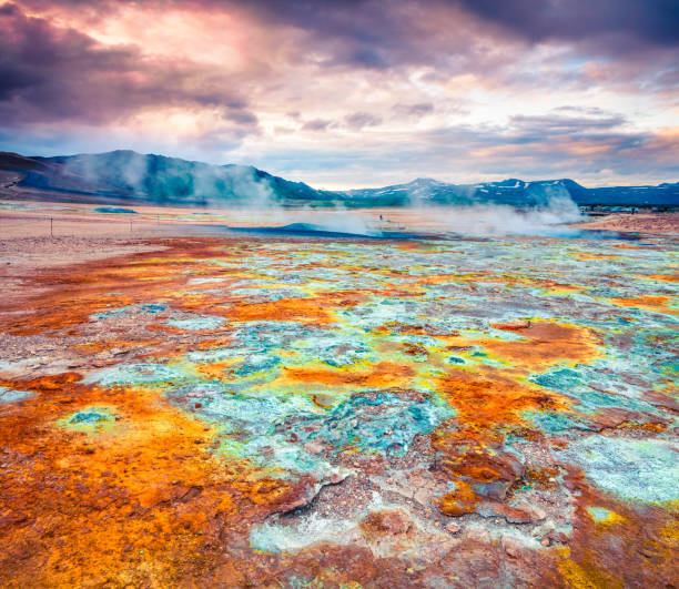 Steaming fumaroles in geothermal valley Hverarond. Exotic summer landscape of volcanic Icelandic landmark, Reykjahlid village location, north Iceland, Europe. Artistic style post processed photo.