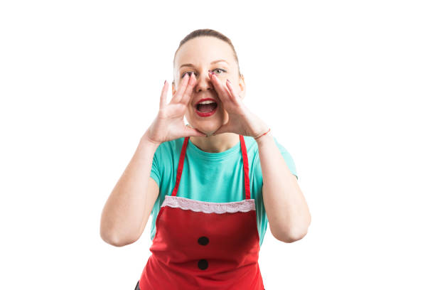 istock Woman with red apron yelling, screaming, shouting to the camera 882168656