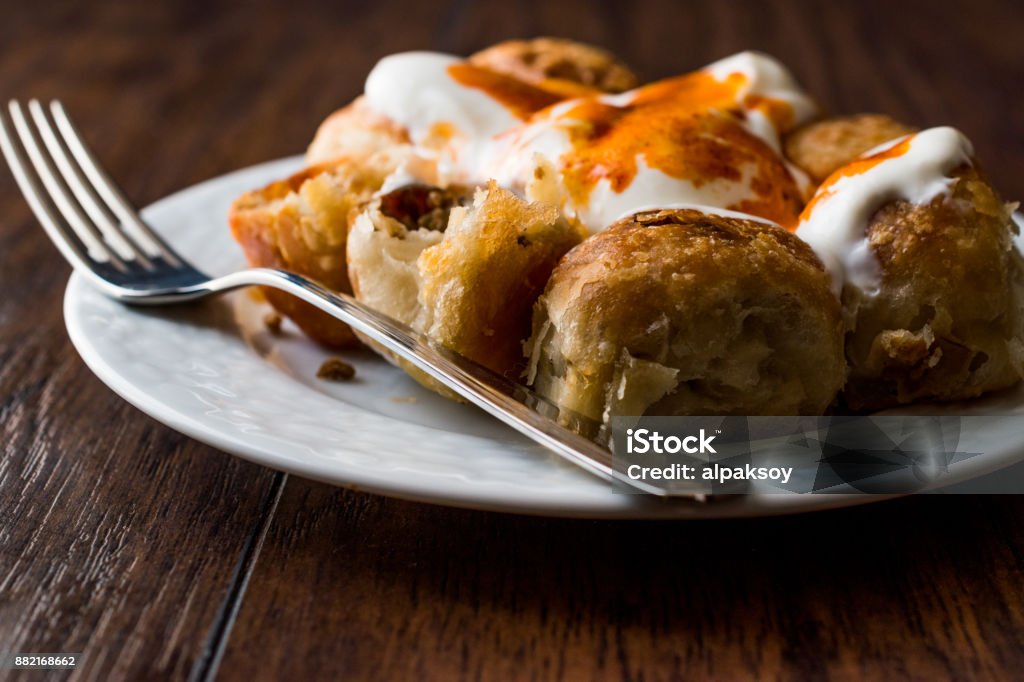 Bosnian Pastry Manti with Yogurt and Fried Butter Sauce / Bosnak Borek Bosnian Pastry Manti with Yogurt and Fried Butter Sauce / Bosnak Borek. Traditional Food. Appetizer Stock Photo