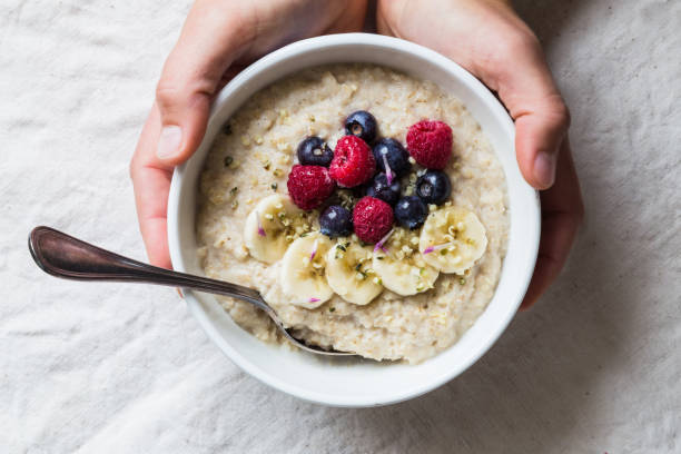 istock Oatmeal with fruit and nuts and mug of tea 882169220