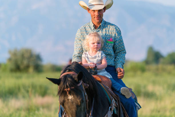 istock Father riding a horse with his young daughter 882176108