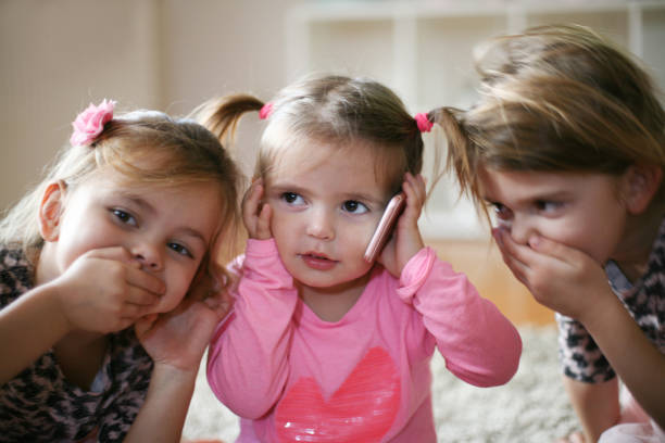 istock Three little girls with mobile phone. 882176462