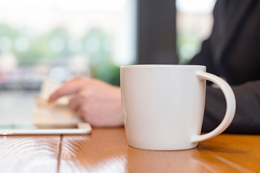 woman having a coffee and book relax in cafe.