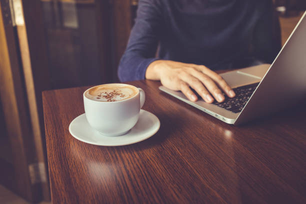 istock Businessman working with laptop and coffee cup on desk 882179486