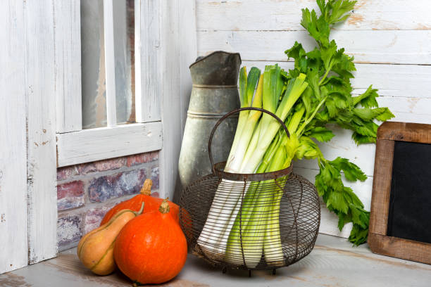 celery stalks and pumpkin on the wooden table