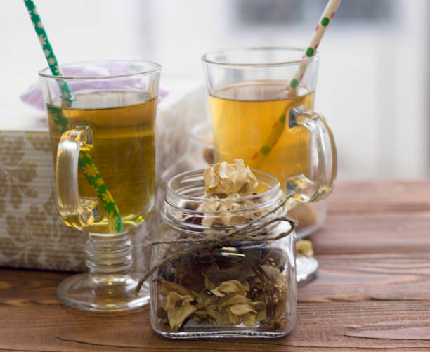 istock Glass tea cups, a jar with dry flowers and a gift box 882179862