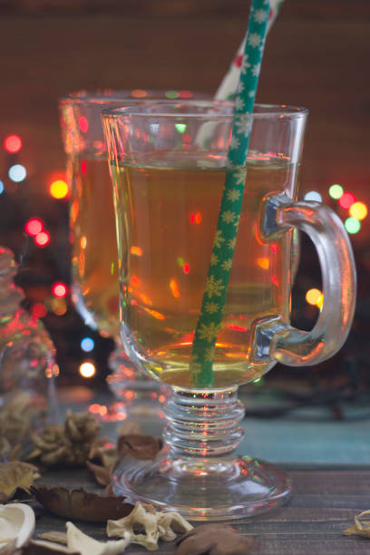 istock Tea cups with straws on a dark bokeh background 882186512