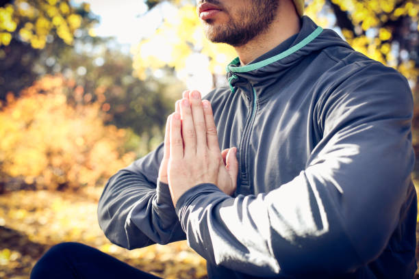 istock Young man exercise yoga. Autumn season. 882186674