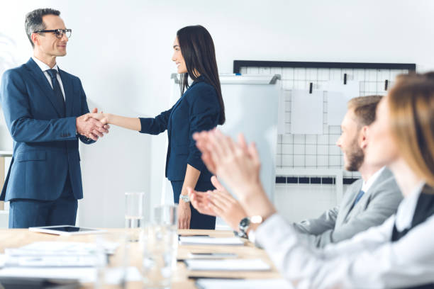 istock boss shaking hand of manageress 882186834