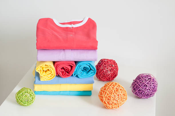 The set of baby items in the stack, toy and blank card on a blue background