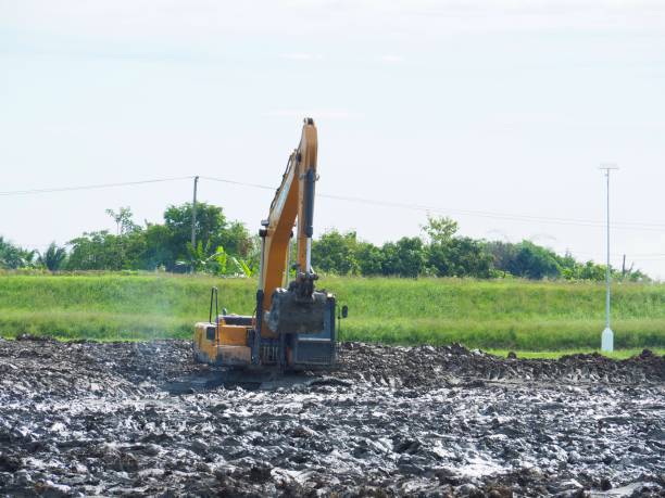istock Makro excavator digging soil to adjust the area. To use the construction, foundation, drainage, agriculture, farm, grassland. 882190058