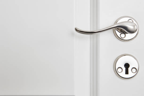 istock Metallic classic door knob on a white door. Open 882190440