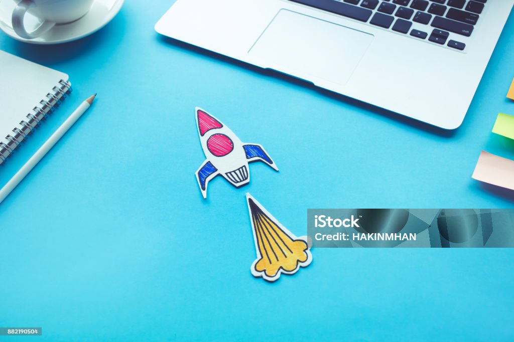 Business start up concept with rocket on desk table.Creativity innovation Business start up concept with rocket on desk table color.Creativity innovation ideas Launch Event Stock Photo