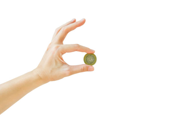 Woman hand tossing a coin isolated on white