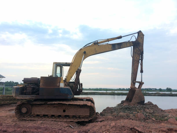 istock An old excavator and tractor with rust and soil working on construction site. 882194782