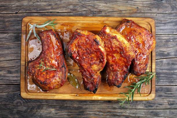 istock juicy Pork Chops on a wooden board 882197408