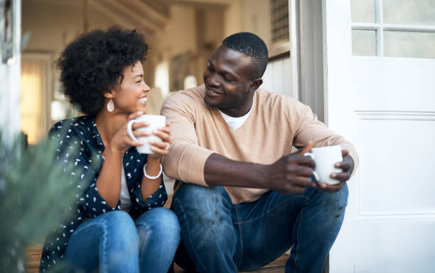 We’re so comfortable with each other Cropped shot of a happy young couple spending time together outside couple drinking stock pictures, royalty-free photos & images