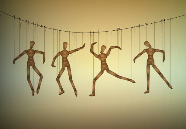 istock many marionette in different positions hanging on the threats, manipulate the people concept, 882208544