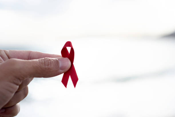 istock man with red ribbon for the fight against AIDS 882208856
