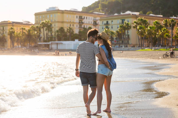 istock Happy couple standing in water enjoying each other 882208884