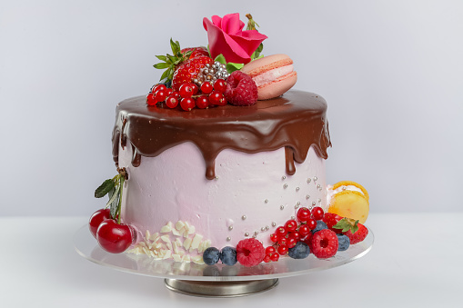 Layer cake with chocolate icing, garnished with fruits
