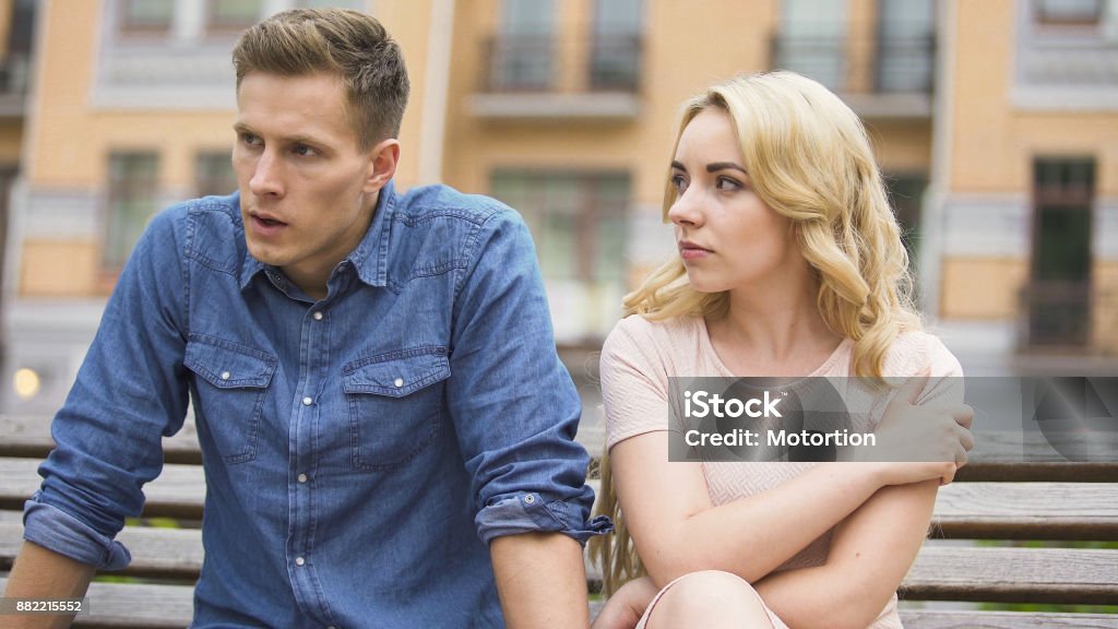 Jealous girl having fight with upset boyfriend, conflict of unhappy people Adult Stock Photo