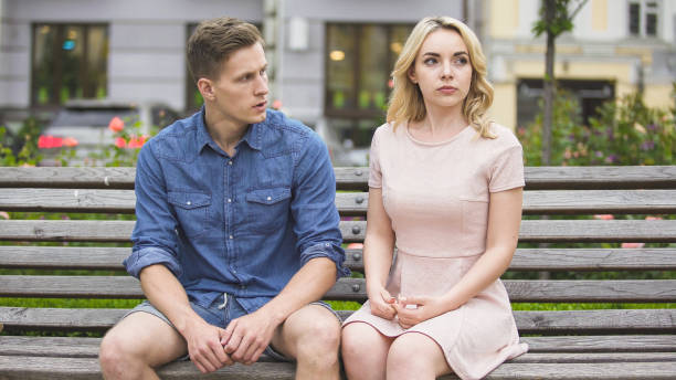 istock Man and woman breaking up on bench in park, conflict in relationship, problem 882216062