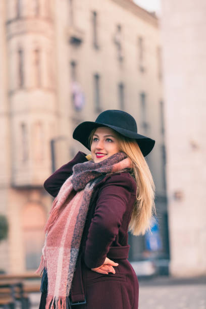 istock Beautiful woman with black hat posing outdoors. Happiness concept. 882221558