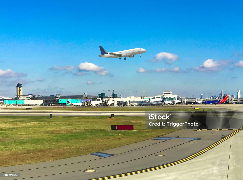 Charlotte International Airport Plane taking off at CLT Airport with skyline in background Airport Stock Photo