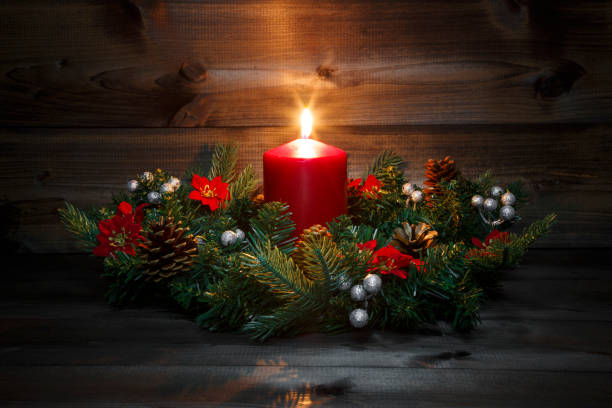 istock First Advent - Decorated Advent wreath with a red burning candle on a wooden background with festive atmosphere 882226178