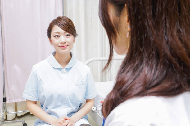istock female doctor and nurse doing a meeting 882228656