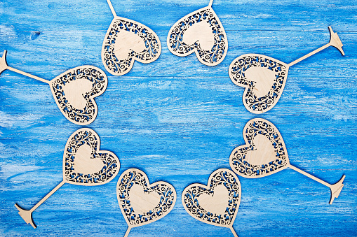 wooden heart carved on a blue wooden background. space for text