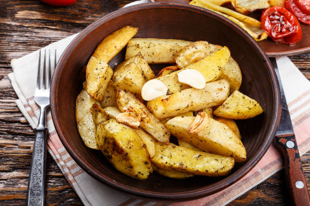 istock baked potatoes with vegetables and herbs on a clay plate. 882229288
