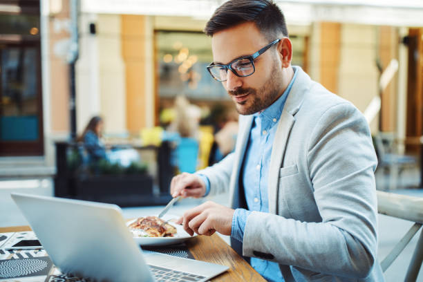 istock Businessman having breakfast in cafe. 882229554