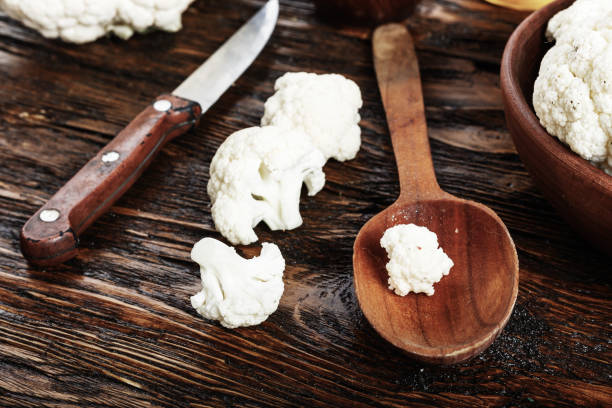 istock Useful cauliflower in  a wooden table in the kitchen. top view 882232184