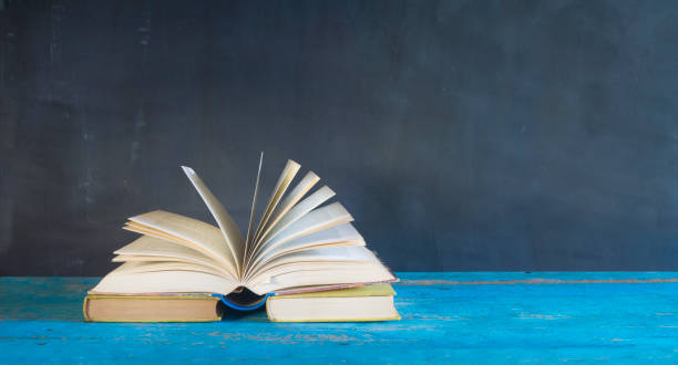 istock opened book on black grungy background 882236290