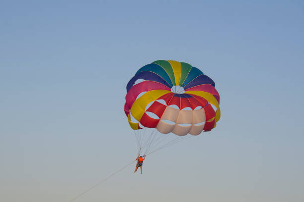 istock man hanggliding in the air 882236812